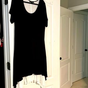 Scoop neck black dress lined in white knit with a flounce white skirt underlay
